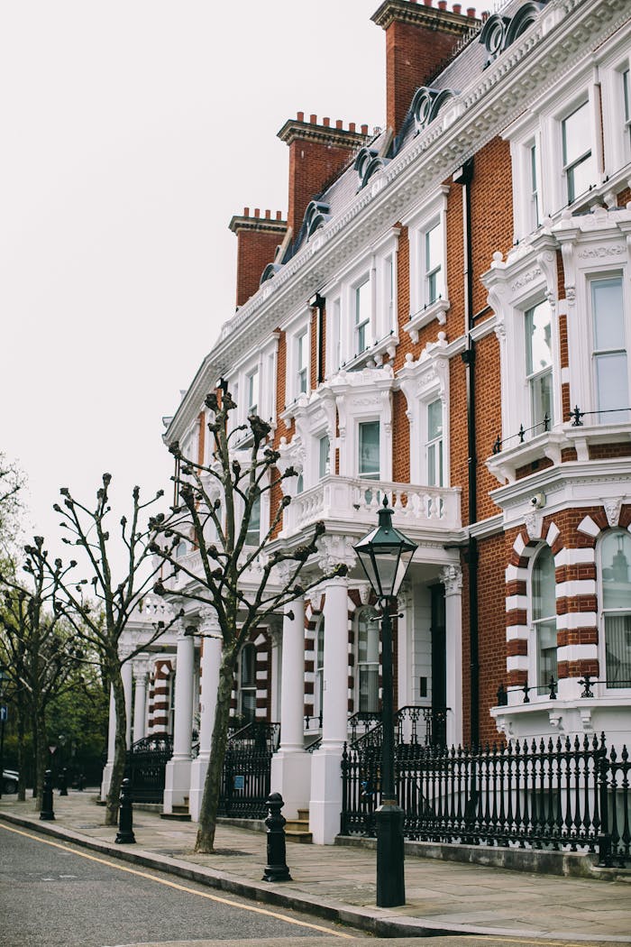gallery-4 Victorian terraced houses with detailed facades on a quiet London street, exuding classic elegance.
