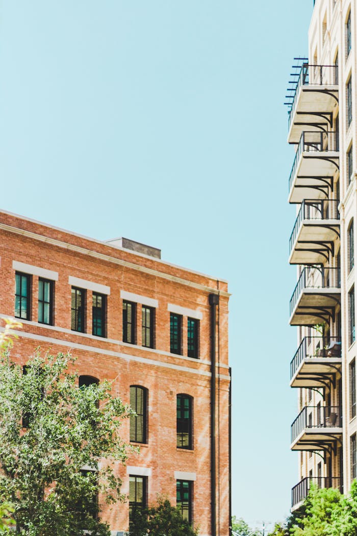 gallery-2 View of modern buildings with balconies against a clear blue sky in San Antonio.